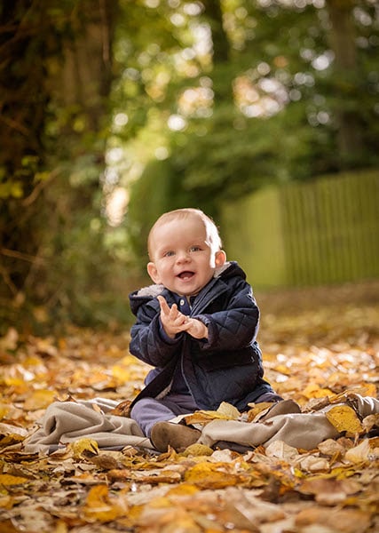 A baby in autumn by a photographer in Warwickshire